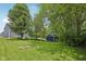 Expansive backyard with lush lawn, storage shed, and charming fire pit area, ideal for entertaining and relaxation at 8241 Holmard Pl, Indianapolis, IN 46259