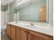 Bathroom with double sinks, wood cabinets, large mirror, and bath/shower combo at 8241 Holmard Pl, Indianapolis, IN 46259