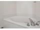 Close up of a bathtub with chrome faucet hardware and white surround at 8241 Holmard Pl, Indianapolis, IN 46259