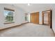 Comfortable bedroom with neutral walls, plush carpet, large closet, and bright windows at 8241 Holmard Pl, Indianapolis, IN 46259