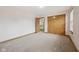 Relaxing bedroom with neutral walls, soft carpet, closet, and views of the outside at 8241 Holmard Pl, Indianapolis, IN 46259