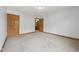 Spacious bedroom with neutral walls, soft carpet, and a bright view into the bathroom at 8241 Holmard Pl, Indianapolis, IN 46259