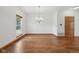 Light-filled dining area with hardwood flooring, modern chandelier, and neutral tones at 8241 Holmard Pl, Indianapolis, IN 46259