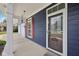 Welcoming front entryway with storm door, red shutters, and an outside light fixture at 8241 Holmard Pl, Indianapolis, IN 46259