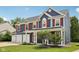 Beautiful two-story home with a three-car garage, covered porch, and freshly cut lawn at 8241 Holmard Pl, Indianapolis, IN 46259