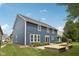 Back exterior of the home featuring a patio, landscaped garden beds and lovely lawn at 8241 Holmard Pl, Indianapolis, IN 46259