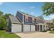 Attractive home boasts a three-car garage, front porch, and well-maintained landscaping at 8241 Holmard Pl, Indianapolis, IN 46259