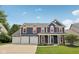 Charming two-story home boasts a three-car garage, well-manicured lawn, and classic curb appeal at 8241 Holmard Pl, Indianapolis, IN 46259