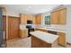 Kitchen with light wood cabinetry, countertops, and black appliances; a functional and stylish design at 8241 Holmard Pl, Indianapolis, IN 46259
