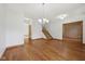 Inviting living room with hardwood floors, staircase, and chandelier at 8241 Holmard Pl, Indianapolis, IN 46259
