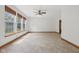 Bright living room with large windows, blinds, tile flooring, and ceiling fan at 8241 Holmard Pl, Indianapolis, IN 46259
