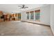 Spacious living room with tile floors, three large windows, and an open floor plan to the kitchen at 8241 Holmard Pl, Indianapolis, IN 46259