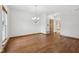 Living room with wood floors, chandelier, and door leading to the kitchen at 8241 Holmard Pl, Indianapolis, IN 46259