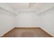 Empty walk-in closet featuring carpeted floors, white walls and wire shelving at 8241 Holmard Pl, Indianapolis, IN 46259
