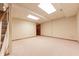Spacious basement area with carpet, a door, white ceiling tiles and ample lighting at 8772 W Evergreen Dr, Columbus, IN 47201