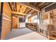 Unfinished basement featuring an open ceiling, painted floor and workbench with sink at 8772 W Evergreen Dr, Columbus, IN 47201