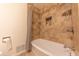 Cozy bathroom featuring a bathtub with decorative tile surround, shower curtain, and neutral tones at 8772 W Evergreen Dr, Columbus, IN 47201