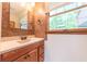 Bathroom featuring a vanity, toilet, and window at 8772 W Evergreen Dr, Columbus, IN 47201