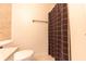 Toilet and shower area with brown shower curtain at 8772 W Evergreen Dr, Columbus, IN 47201