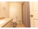 This bathroom features a toilet, vanity, and shower with a curtain at 8772 W Evergreen Dr, Columbus, IN 47201