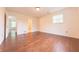 Bedroom featuring hardwood floors and ample natural light from large windows and a view of the bathroom at 8772 W Evergreen Dr, Columbus, IN 47201