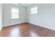 This bedroom has hardwood floors and two windows at 8772 W Evergreen Dr, Columbus, IN 47201