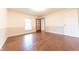 Bright bedroom with hardwood floors, a window, paneled accent wall, and a traditional door at 8772 W Evergreen Dr, Columbus, IN 47201