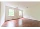 Bedroom featuring hardwood floors and ample natural light from large windows at 8772 W Evergreen Dr, Columbus, IN 47201