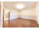 Wood flooring, paneled accent wall, window, and doorways create a bright and spacious bedroom at 8772 W Evergreen Dr, Columbus, IN 47201