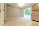 Open dining area with tile floors, sliding glass door access to the backyard, and kitchen views at 8772 W Evergreen Dr, Columbus, IN 47201
