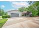 Wide driveway with a 2 car garage and a covered carport for extra parking at 8772 W Evergreen Dr, Columbus, IN 47201