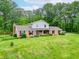 A beautiful home with mature trees and manicured landscaping at 8772 W Evergreen Dr, Columbus, IN 47201