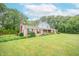 Traditional style two-story home with a manicured front lawn and landscaping at 8772 W Evergreen Dr, Columbus, IN 47201