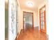 Foyer featuring hardwood floors, a glass door, and traditional doors leading to other rooms at 8772 W Evergreen Dr, Columbus, IN 47201
