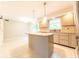 Well-lit kitchen features granite countertops, tiled backsplash, stainless appliances, and an island with pendant lighting at 8772 W Evergreen Dr, Columbus, IN 47201