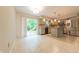 Open kitchen area with tile floors, stainless steel appliances, island, and a view of the backyard at 8772 W Evergreen Dr, Columbus, IN 47201