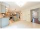 Bright eat-in kitchen featuring an island, stainless steel appliances, tile backsplash and tiled flooring at 8772 W Evergreen Dr, Columbus, IN 47201