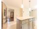 Bright kitchen featuring stainless steel appliances, a granite island with pendant lighting, and tile flooring at 8772 W Evergreen Dr, Columbus, IN 47201