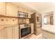 Cozy kitchen with stainless steel appliances and plenty of natural light at 8772 W Evergreen Dr, Columbus, IN 47201