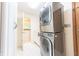 Laundry room featuring a stacked washer and dryer unit with cabinet space and natural light at 8772 W Evergreen Dr, Columbus, IN 47201