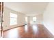 Spacious living room featuring hardwood floors and ample natural light from large windows at 8772 W Evergreen Dr, Columbus, IN 47201