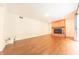 Spacious living room featuring hardwood floors, a brick fireplace, and a sliding glass door at 8772 W Evergreen Dr, Columbus, IN 47201