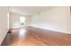 Spacious living room featuring hardwood floors and ample natural light from a large window at 8772 W Evergreen Dr, Columbus, IN 47201