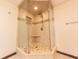 Tiled corner shower with glass enclosure, built in niche, shower head and handheld sprayer at 8772 W Evergreen Dr, Columbus, IN 47201