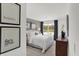 Bright bedroom with natural light, clean white linens, and decorative wall art at 8853 Alexander Ridge Dr, McCordsville, IN 46055