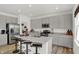 Well-lit kitchen with stainless steel appliances, a central island, and granite countertops at 8853 Alexander Ridge Dr, McCordsville, IN 46055