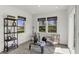 Bright and airy living room featuring shiplap walls, plush rug, and abundant natural light through large windows at 8853 Alexander Ridge Dr, McCordsville, IN 46055