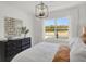 Inviting main bedroom with white walls, modern light fixture, and large windows providing scenic views with luxury details at 8853 Alexander Ridge Dr, McCordsville, IN 46055
