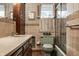 Bathroom with vintage fixtures including a green toilet, bathtub and sink vanity at 8905 Washington Blvd West Dr, Indianapolis, IN 46240