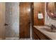 Bathroom featuring a wood vanity with granite countertop and a rose-trimmed mirror at 8905 Washington Blvd West Dr, Indianapolis, IN 46240